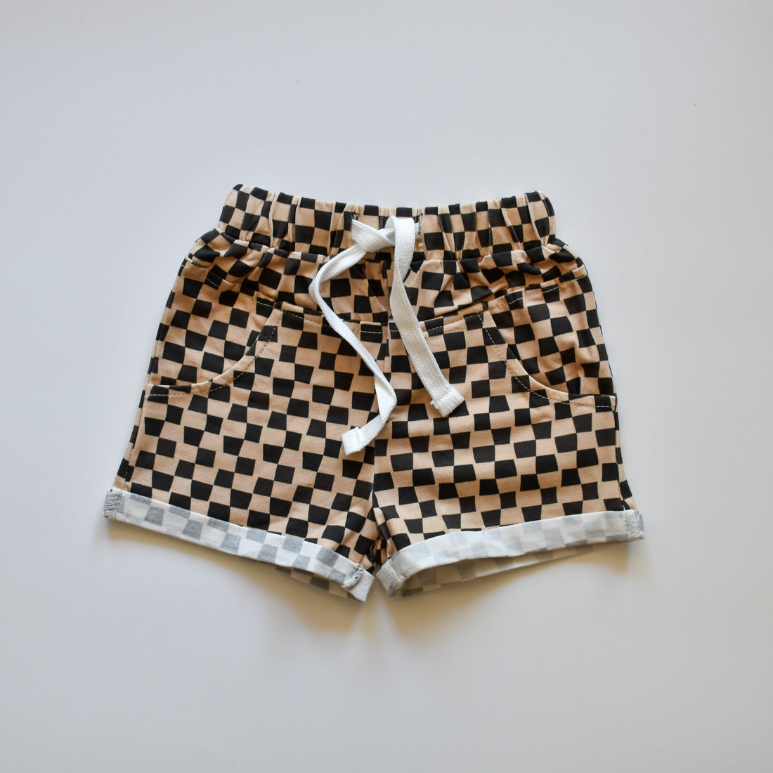 Brown beige checkered toddler shorts with white drawstring.