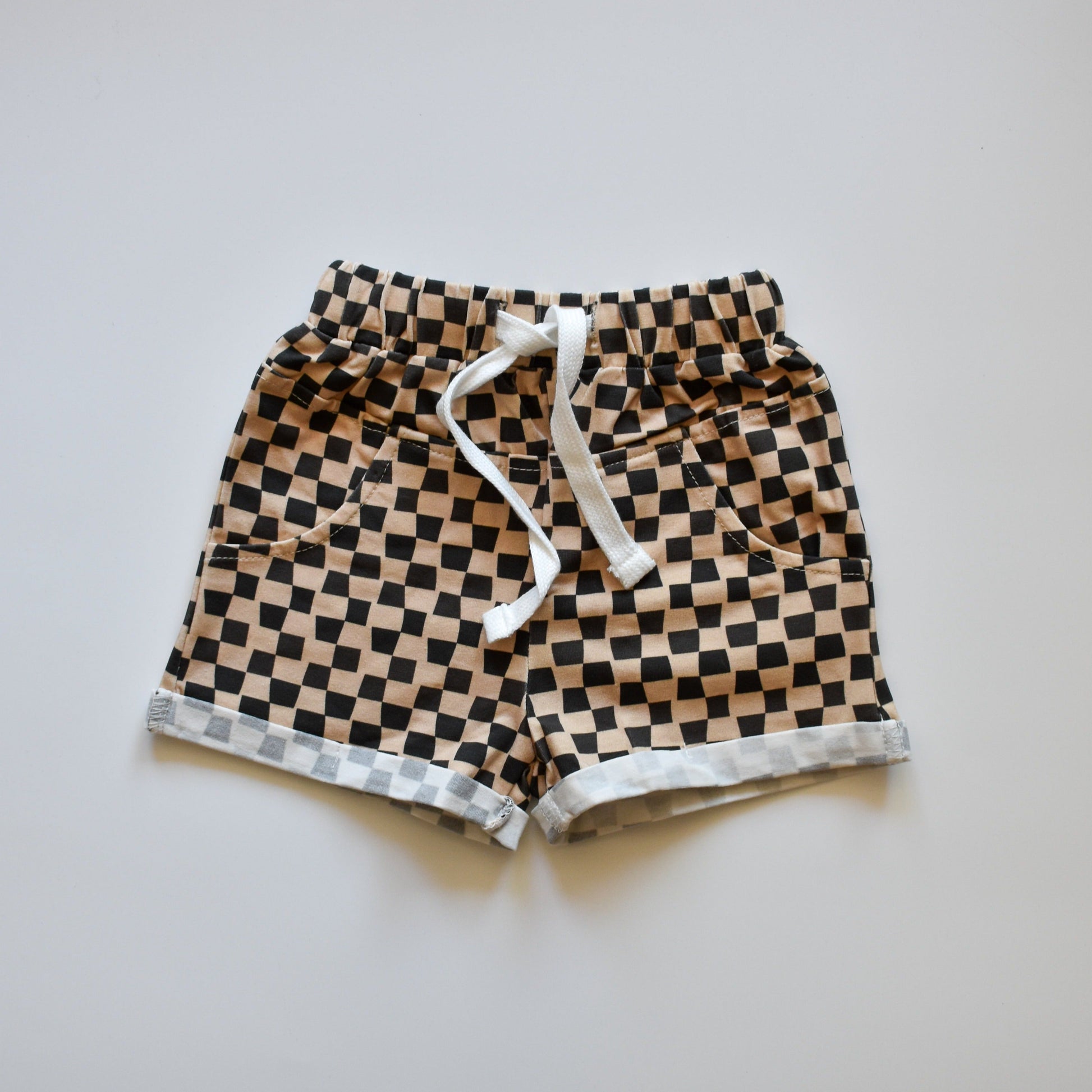 Brown beige checkered toddler shorts with white drawstring.