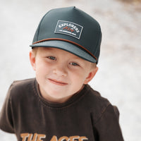 Two boys running; one wears the Juniper Green Explorer Snapback Hat.