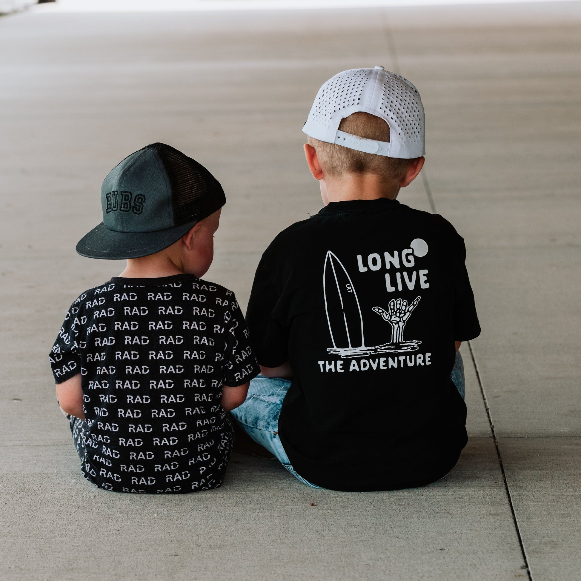 Two boys wearing Long Live The Adventure black tee and RAD tee.