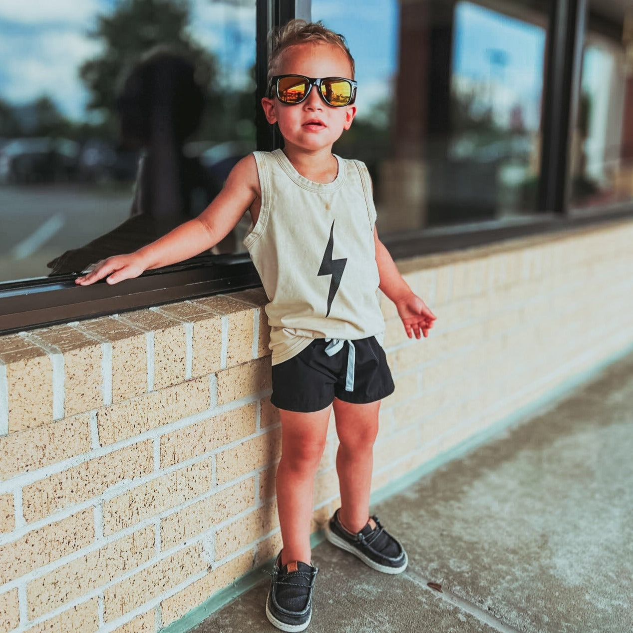 Cool toddler in greige Spark Muscle Tank and black shorts