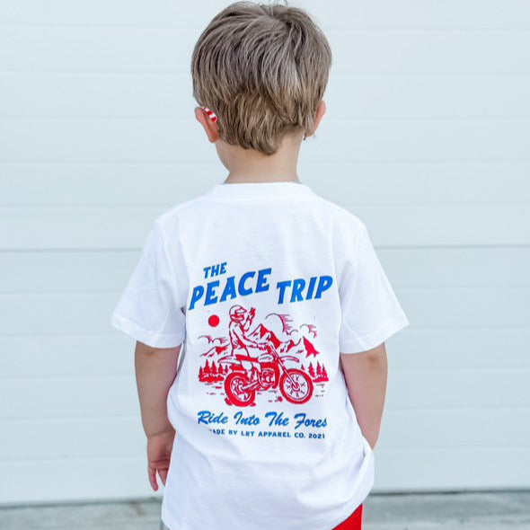 Boy wearing white Peace Trip Tee with motorcycle graphic