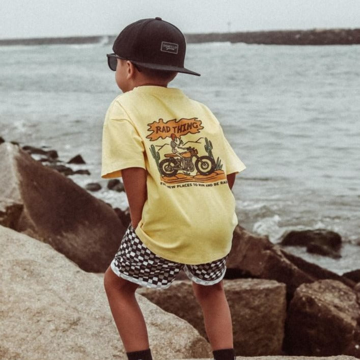 Boy in Golden Yellow 'Where the Rad Things Are' tee with motorcycle graphic.
