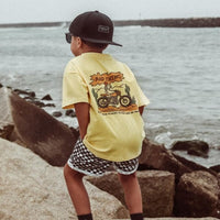 Boy in Golden Yellow 'Where the Rad Things Are' tee with motorcycle graphic.