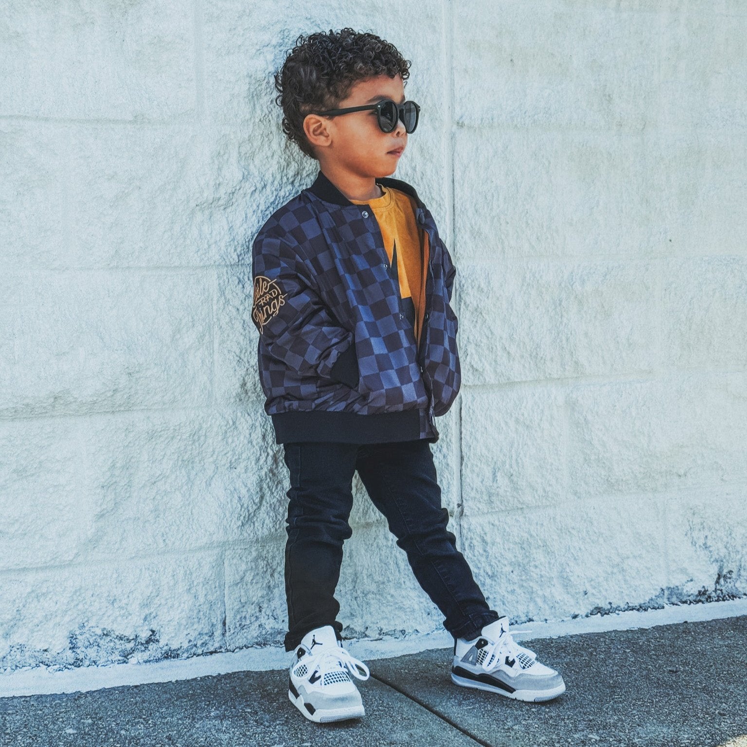 Boy in checkered letterman jacket