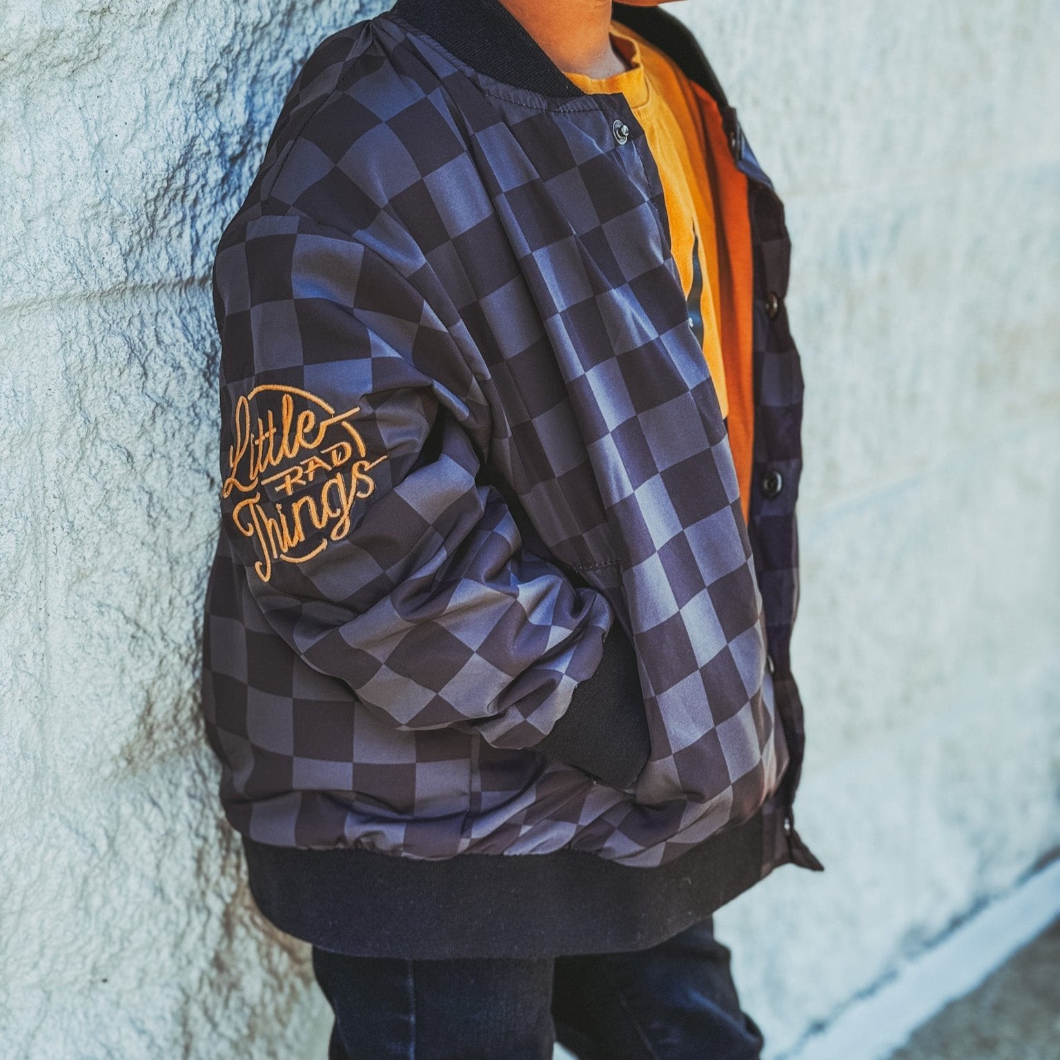 Boy in checkered letterman jacket