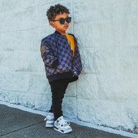 Toddler in Ocean Cubs Wear checkered letterman jacket with sunglasses
