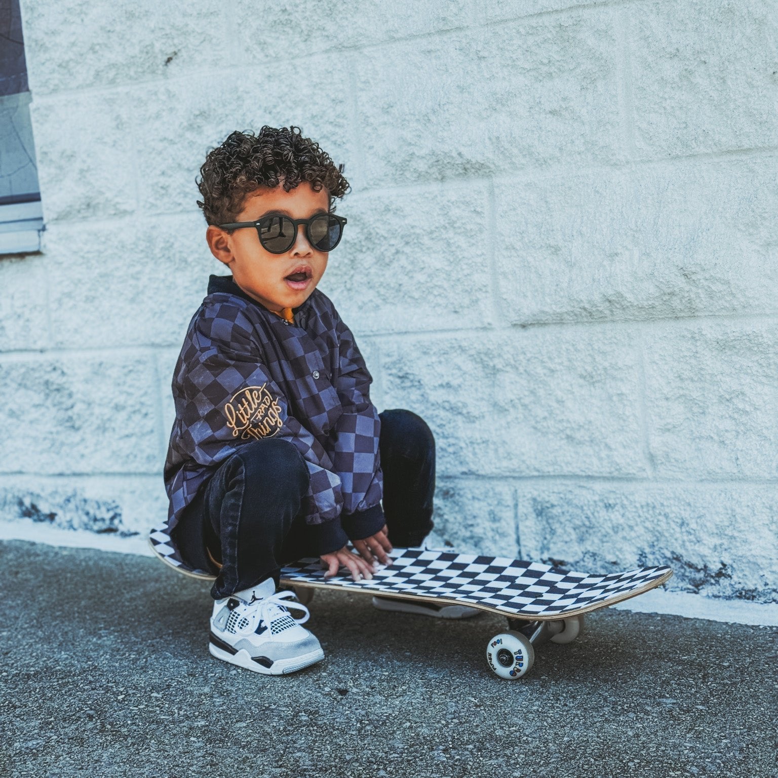 Boy in checkered letterman jacket