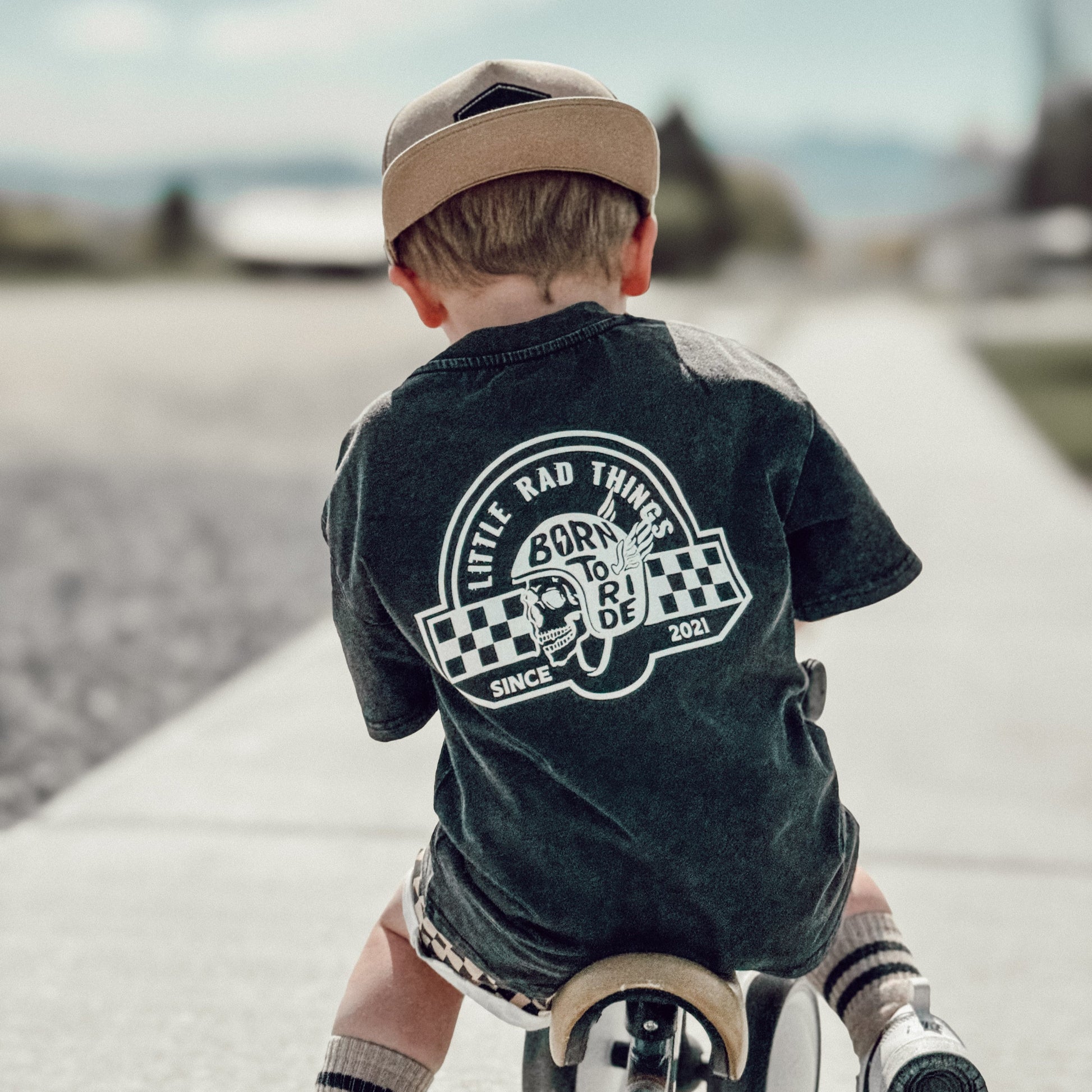 Toddler on bike wearing 'Til Death Do We Ride' graphic tee