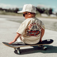 Boy wearing Queen City Garage Tee with a racing car graphic.