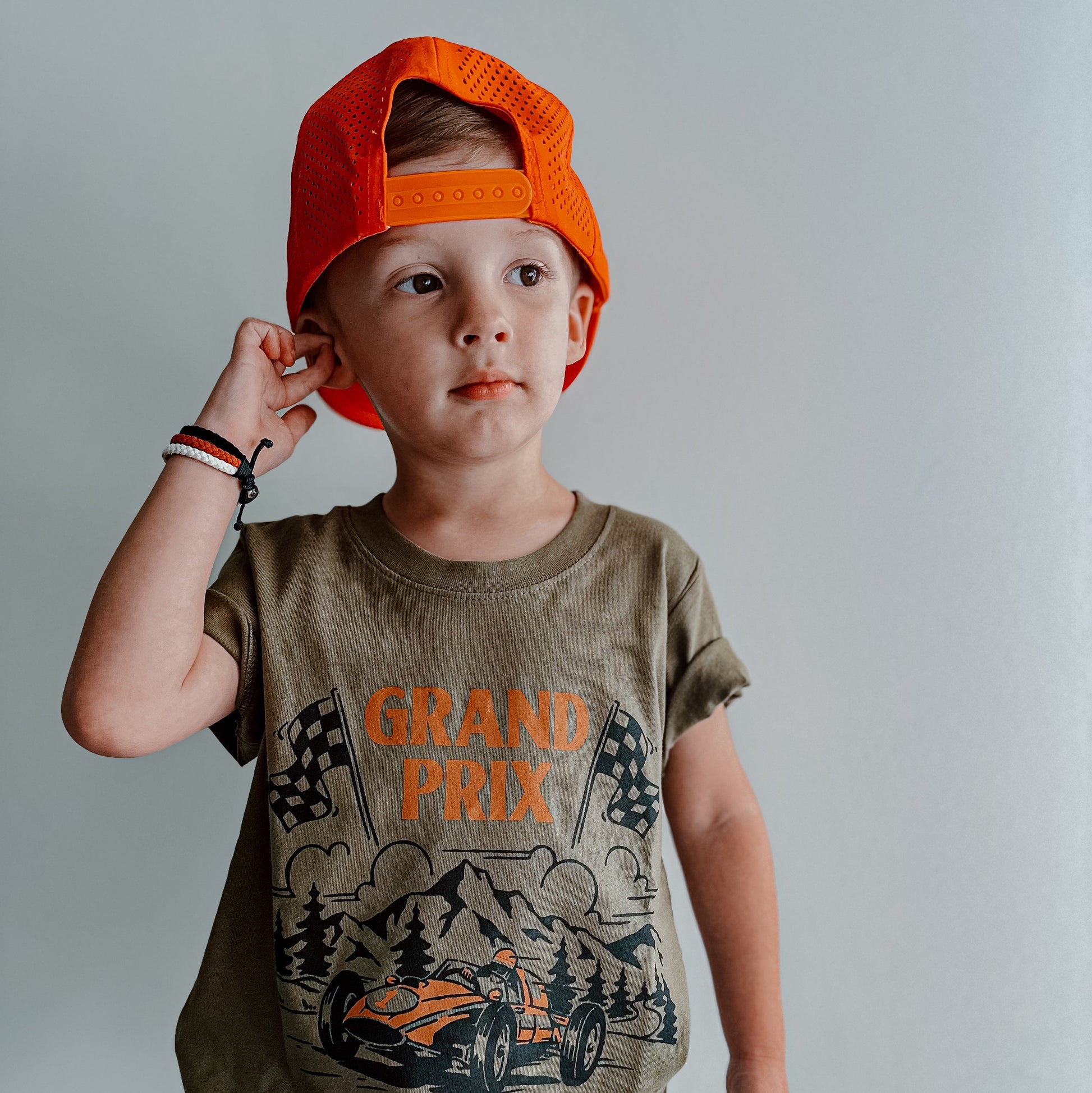Military green Grand Prix de Rad Things t-shirt on hanger.
