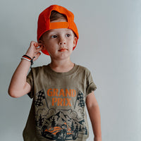 Military green Grand Prix de Rad Things t-shirt on hanger.