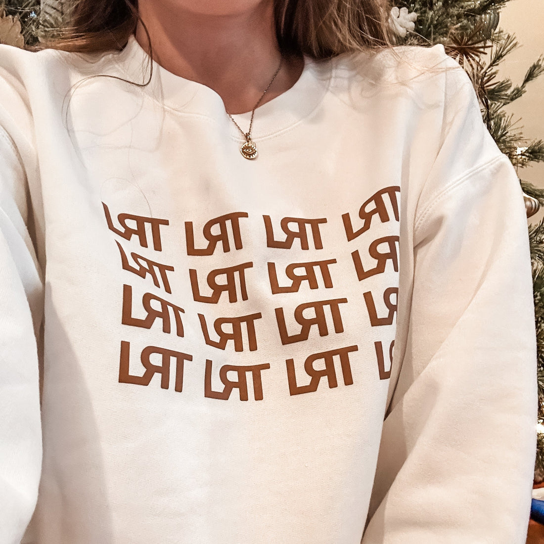 Adult LRT Repeat Logo Crew Sweatshirt in cream with brown logo.