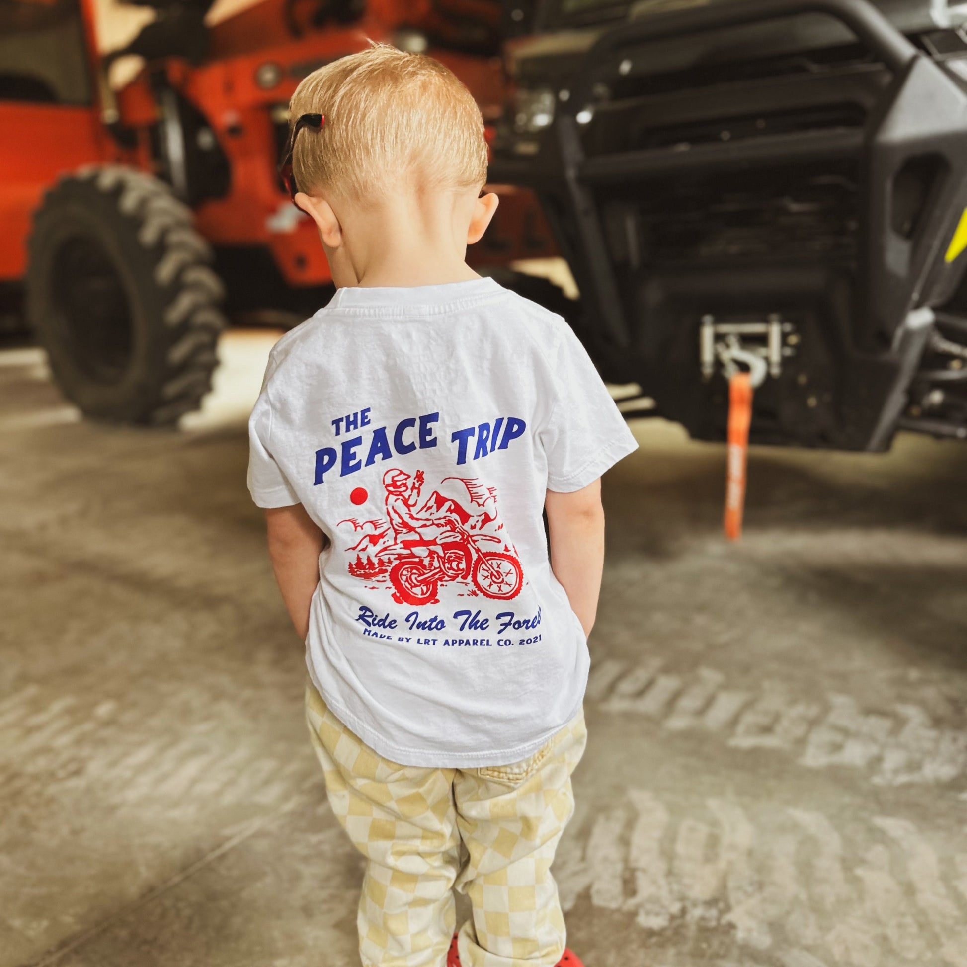 Young child wearing the Peace Trip Tee shirt.