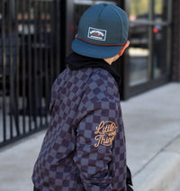 Close-up of Juniper Green Explorer Snapback Hat worn outdoors.