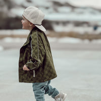 Army green Storm Rider waterproof jacket with subtle checkerboard pattern.