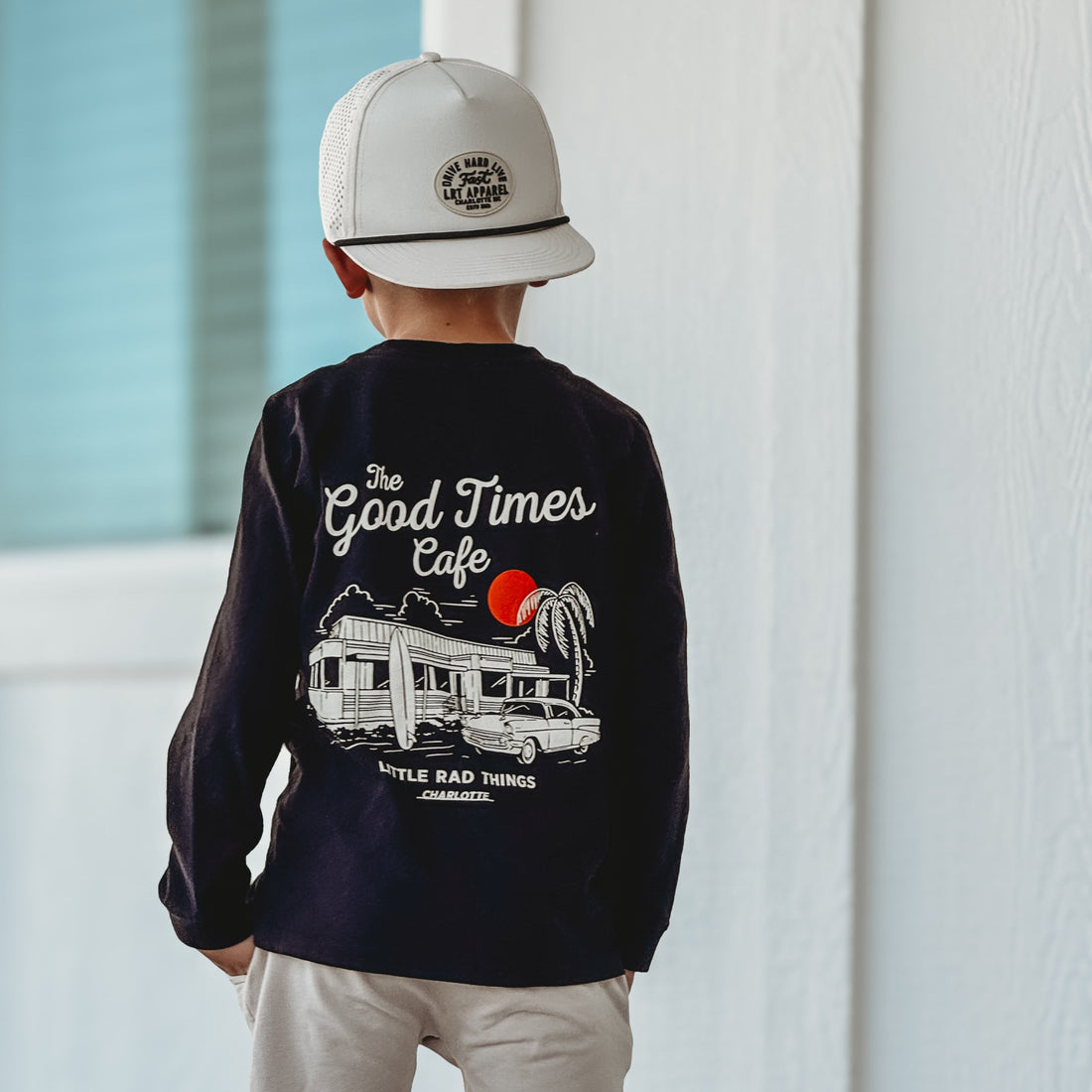 Boy wearing Good Times Cafe black long sleeve shirt.