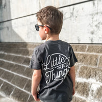 Boy in smoke RAD CIRCLE LOGO TEE with 'Little Rad Things' design, back view.