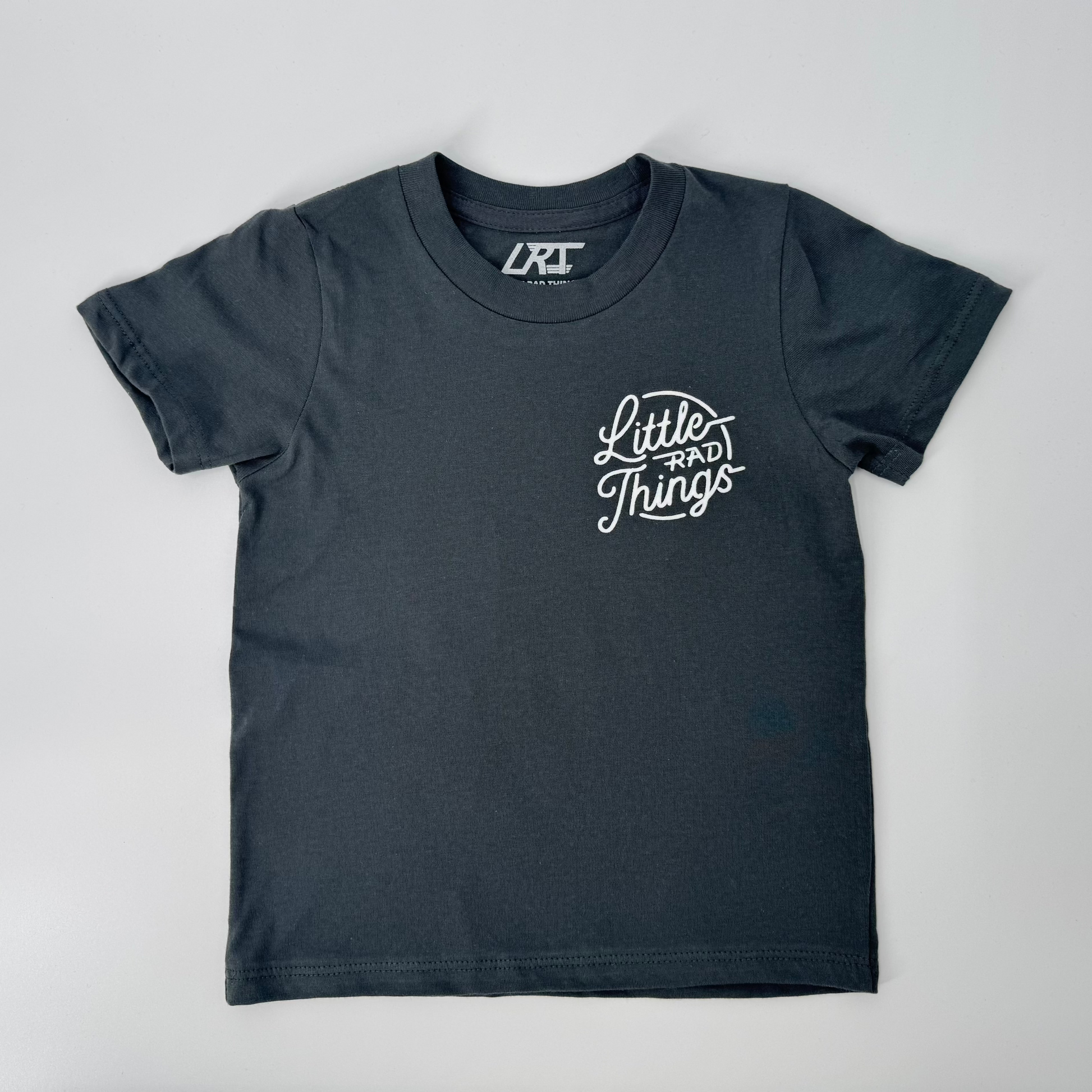 Close-up of smoke RAD CIRCLE LOGO TEE with 'Little Rad Things' graphic.