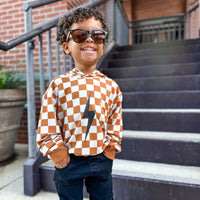 Rust checkered spark hoodie on a hanger