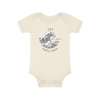 Close-up of cream Dope Threads Swell Days onesie with wave design.