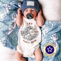 Baby wearing Dope Threads Swell Days onesie with 'Made in Los Angeles' badge.