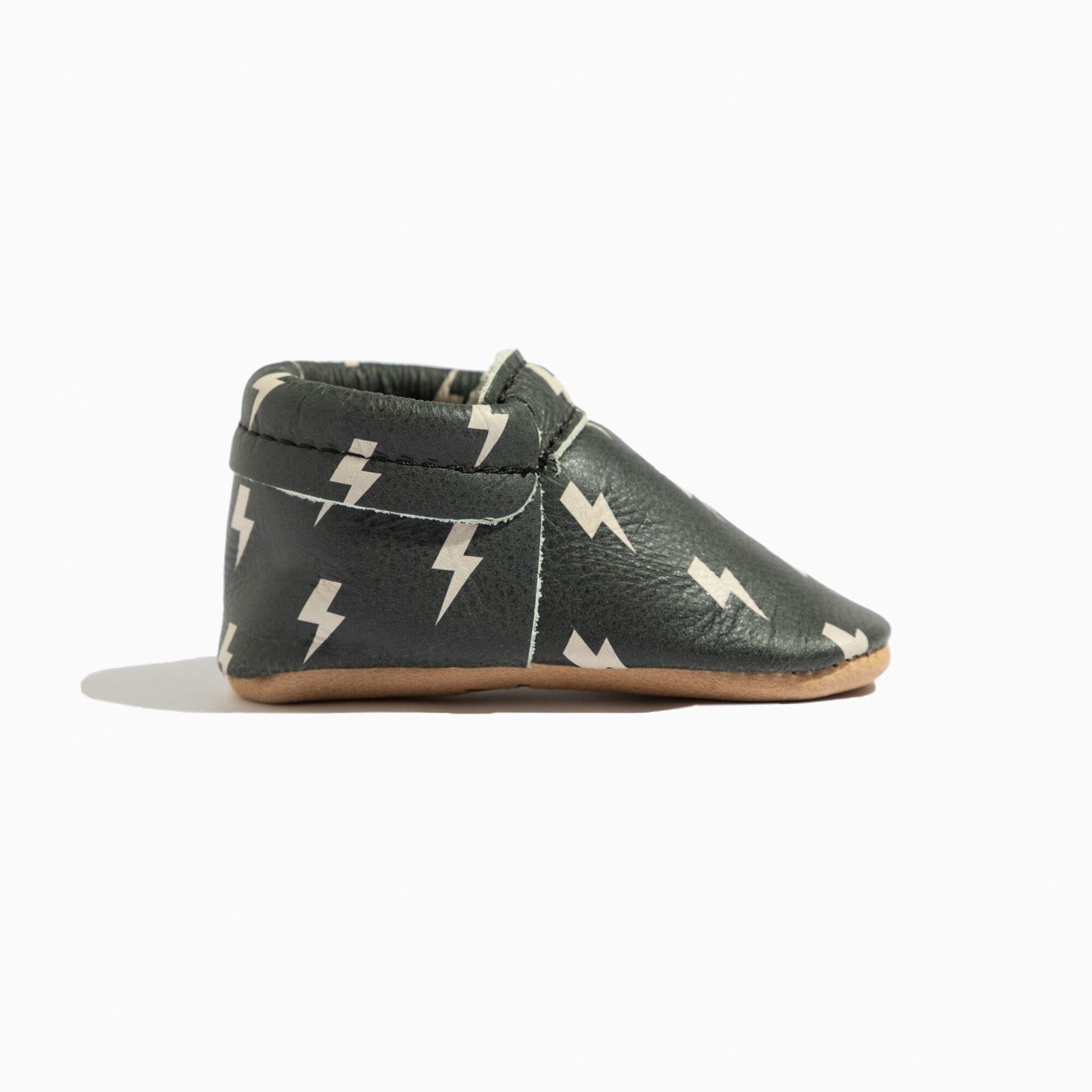 Side view of Ebony Lightning City Baby Shoe, showing elastic opening.