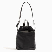Front view of the Jet Motion Bucket Crossbody bag with a striped strap.