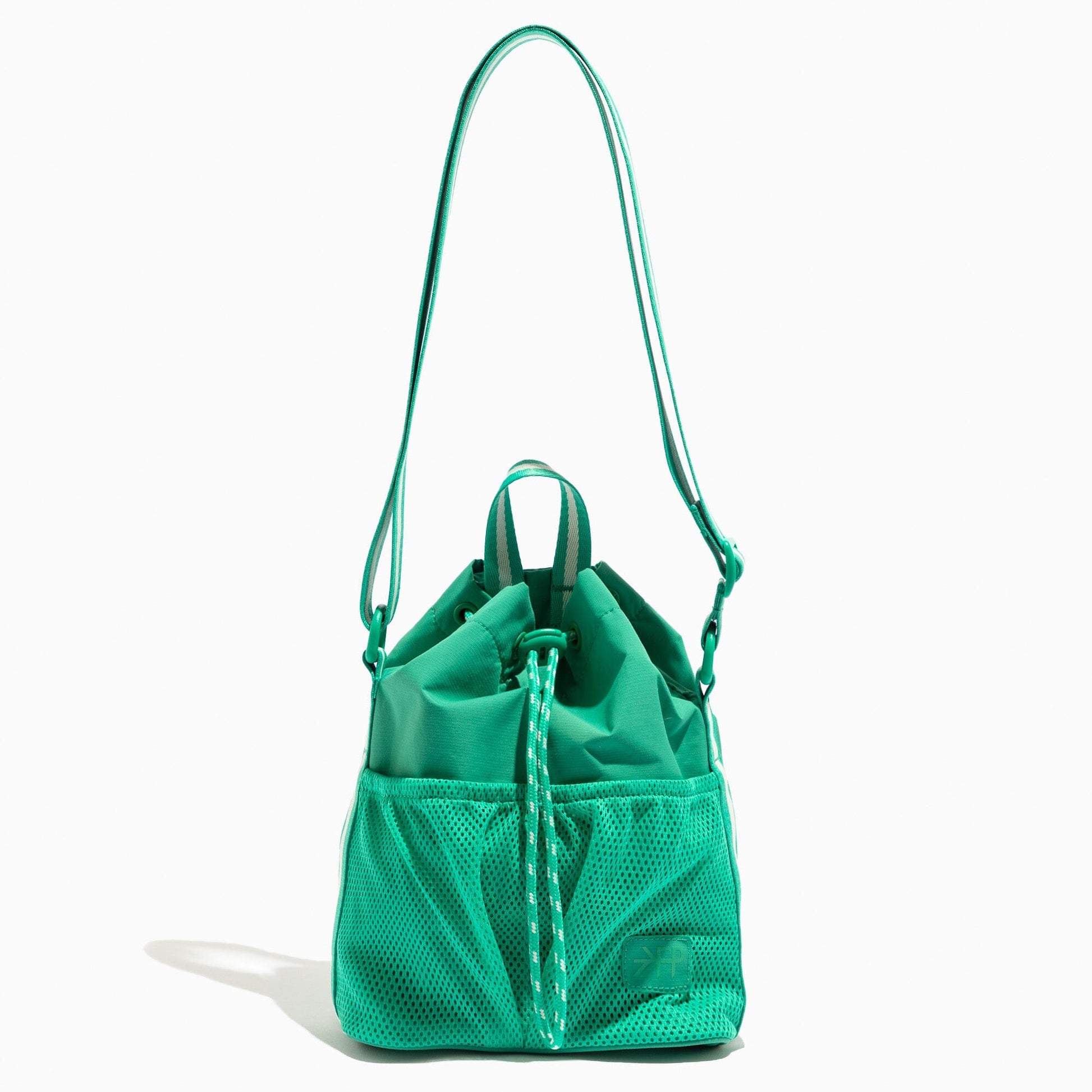 Kelly Motion Bucket Crossbody bag in green with drawstring and crossbody strap.