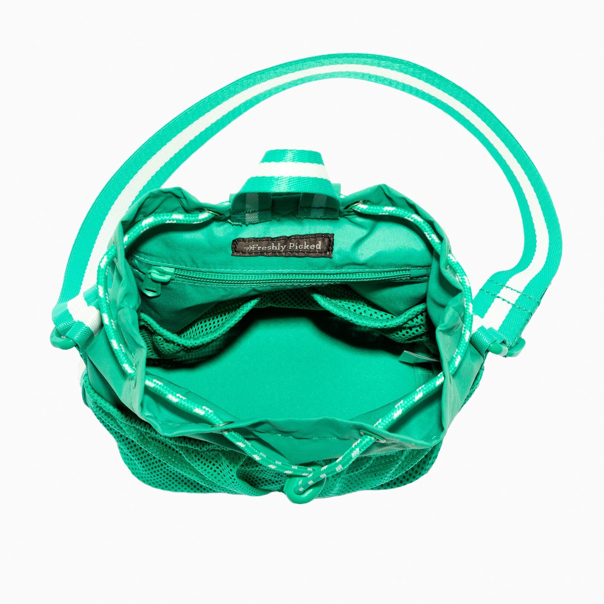 The inside of the Kelly Motion Bucket Crossbody bag in green.