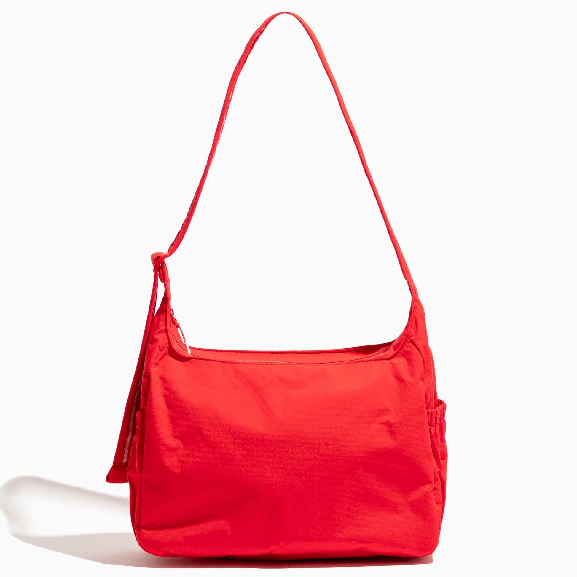 Studio shot of a red Cherry Motion Carryall Tote bag.