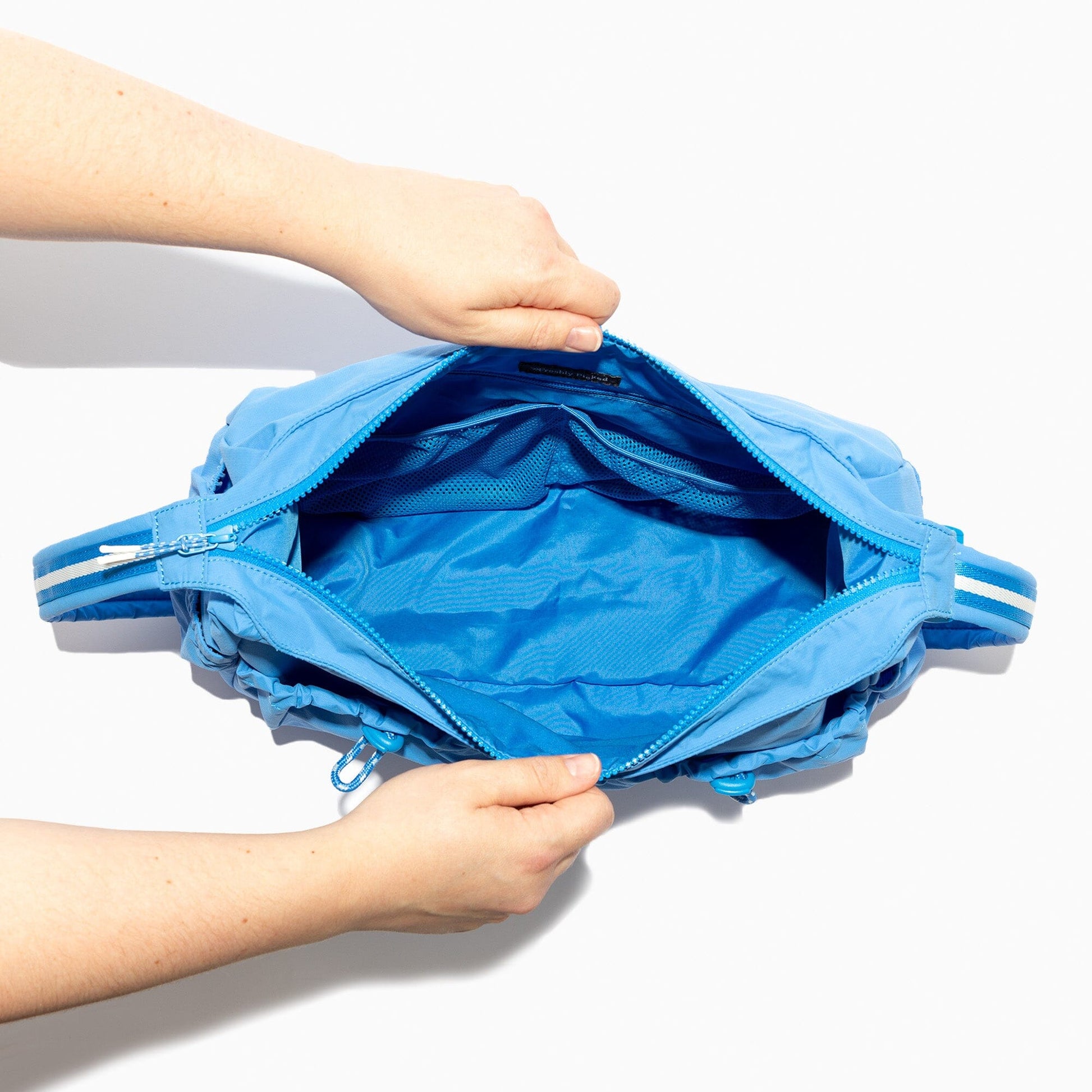 Open blue Wave Motion Carryall Tote showcasing interior and zipper.