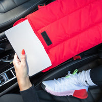 Red Wave Motion Laptop Sleeve holding a laptop in a car seat.
