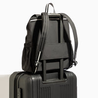 Jet Motion backpack in black with luggage sleeve on suitcase