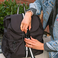 Jet Motion Backpack in black, sitting on a table.