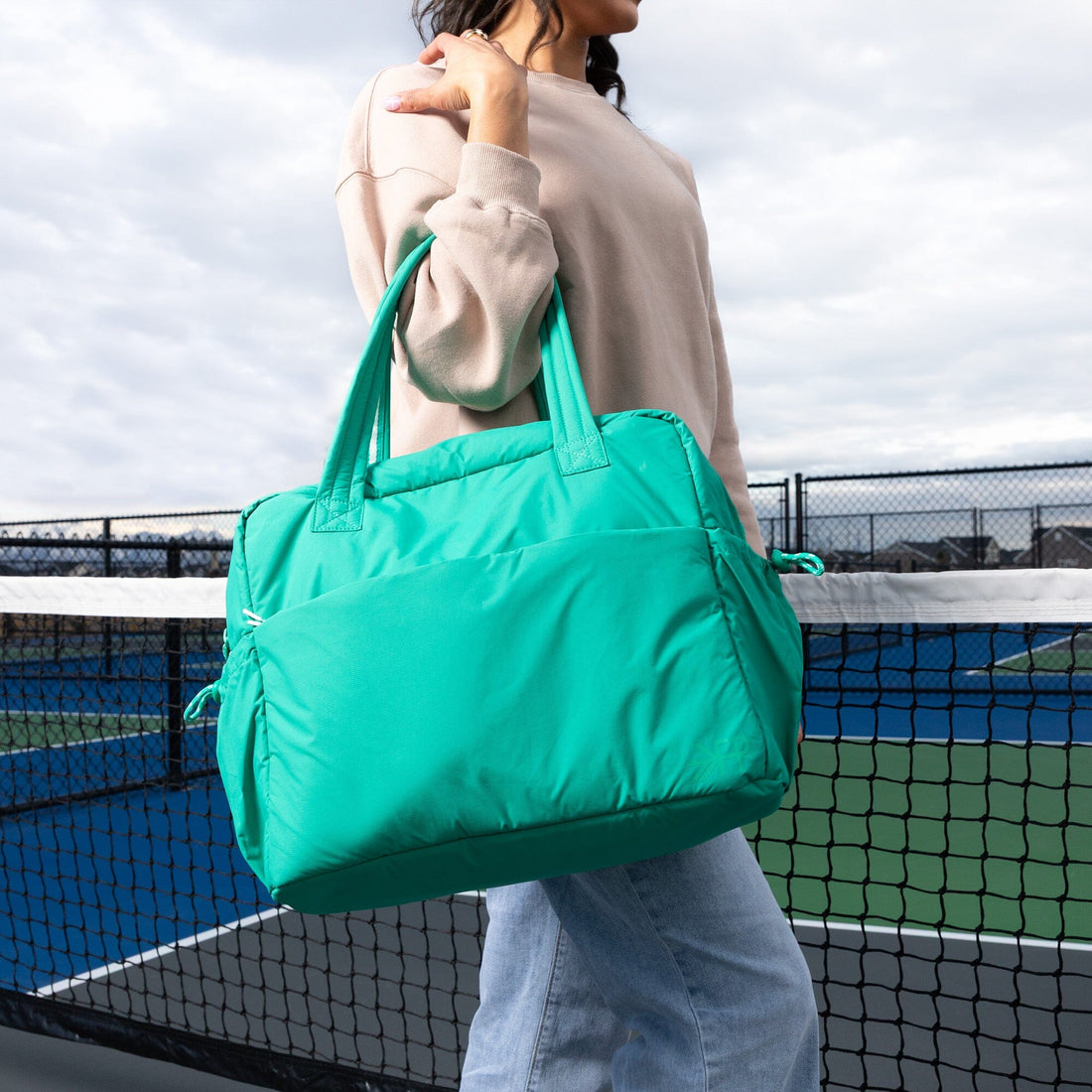Kelly Motion Overnight Duffle in green worn as shoulder bag outdoors