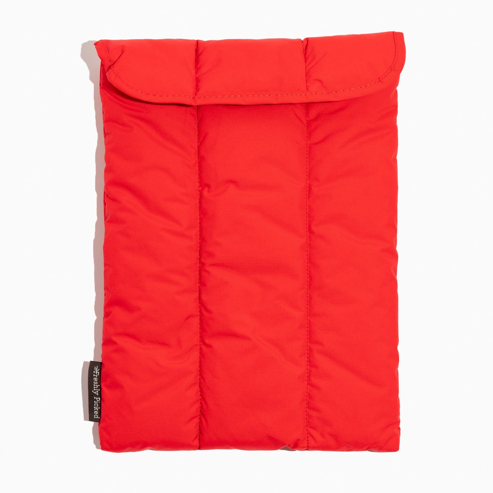 Front view of the Cherry Motion Laptop Sleeve in red with a quilted pattern.
