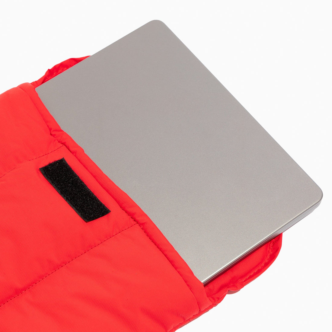 Red Cherry Motion Laptop Sleeve with a laptop inside, showcasing the velcro closure.