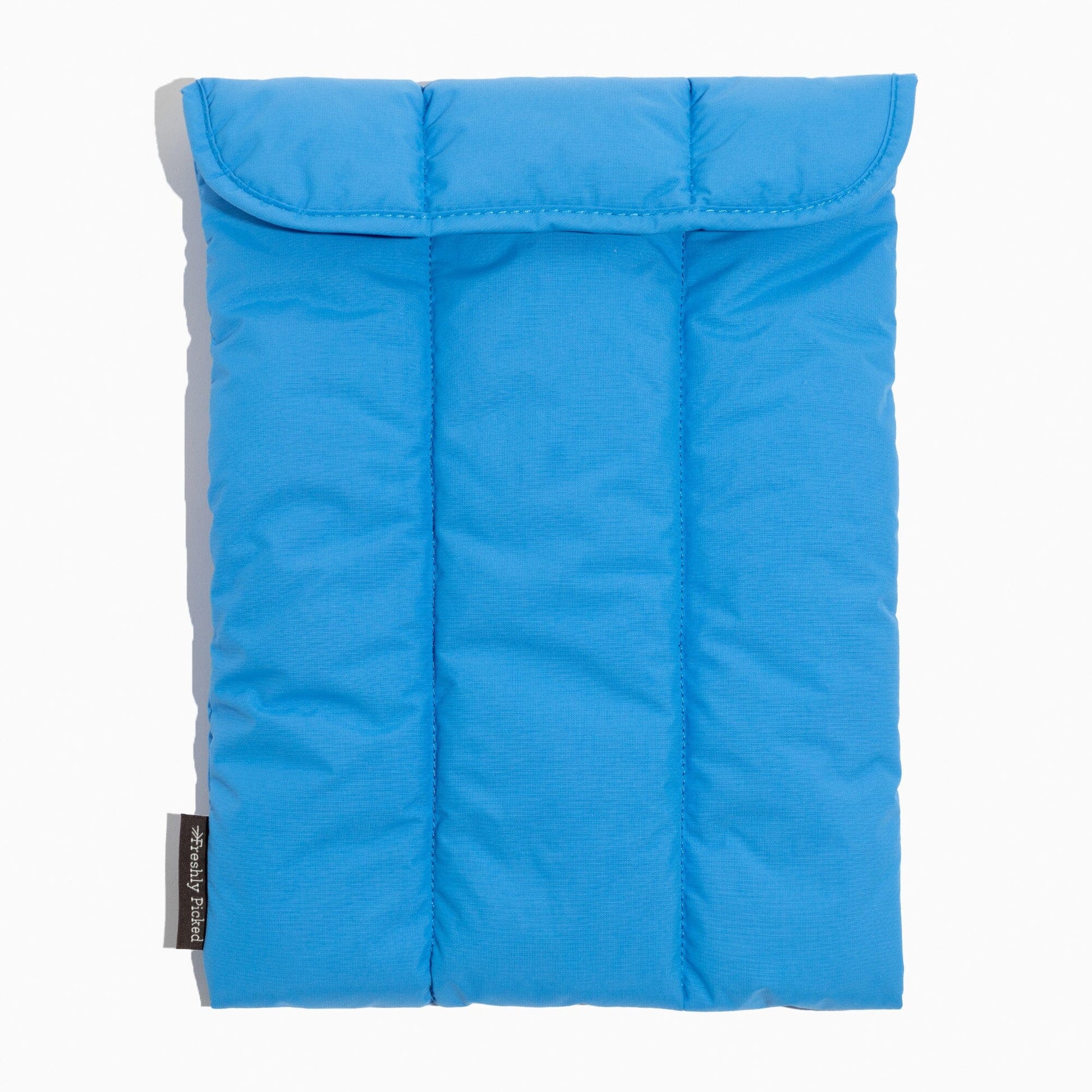 Close-up of the blue Wave Motion Laptop Sleeve with a velcro flap closure.