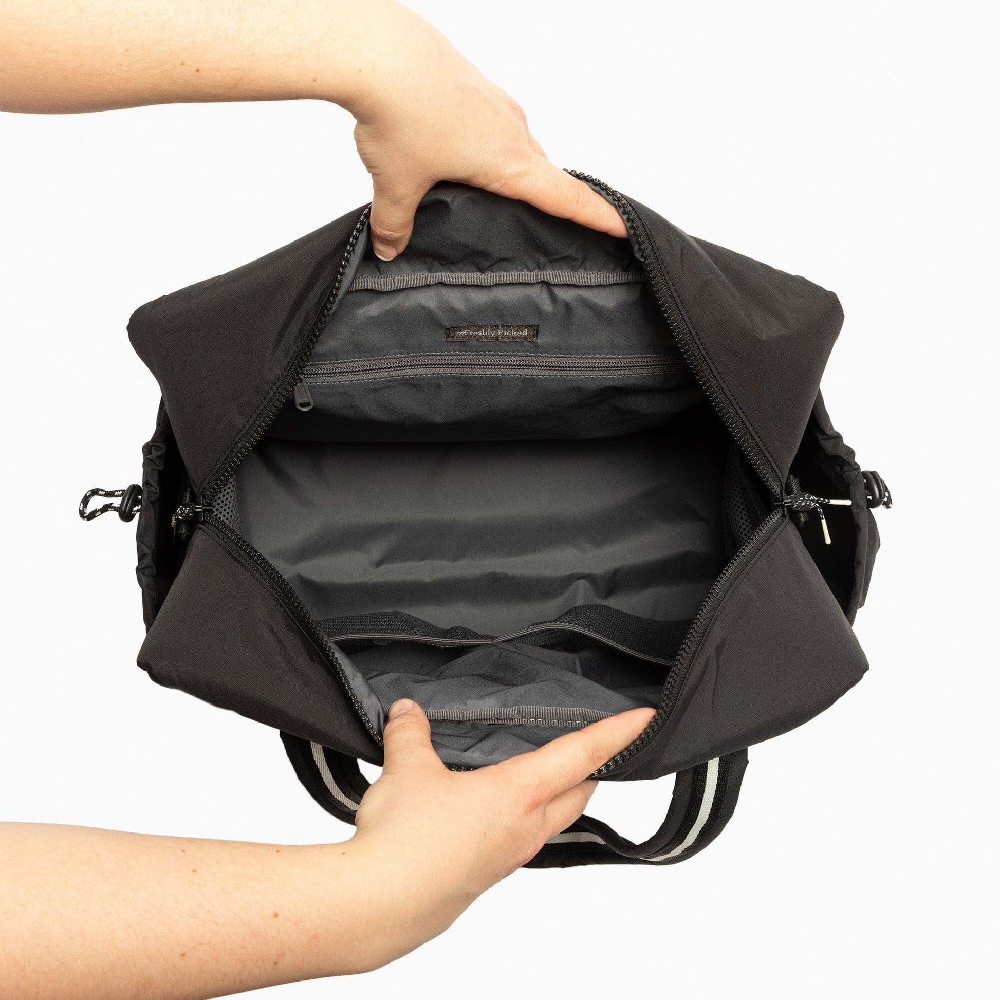 Interior view of the Jet Motion Overnight Duffle showing zipper pocket and storage space.