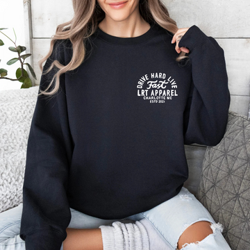 Woman in black Apex crewneck sweatshirt with 'Drive Hard Live Fast' graphic.