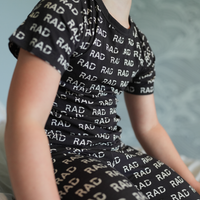 Close-up of black RAD print short sleeve pajama set.