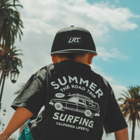 Child wearing black LRT snapback and graphic tee