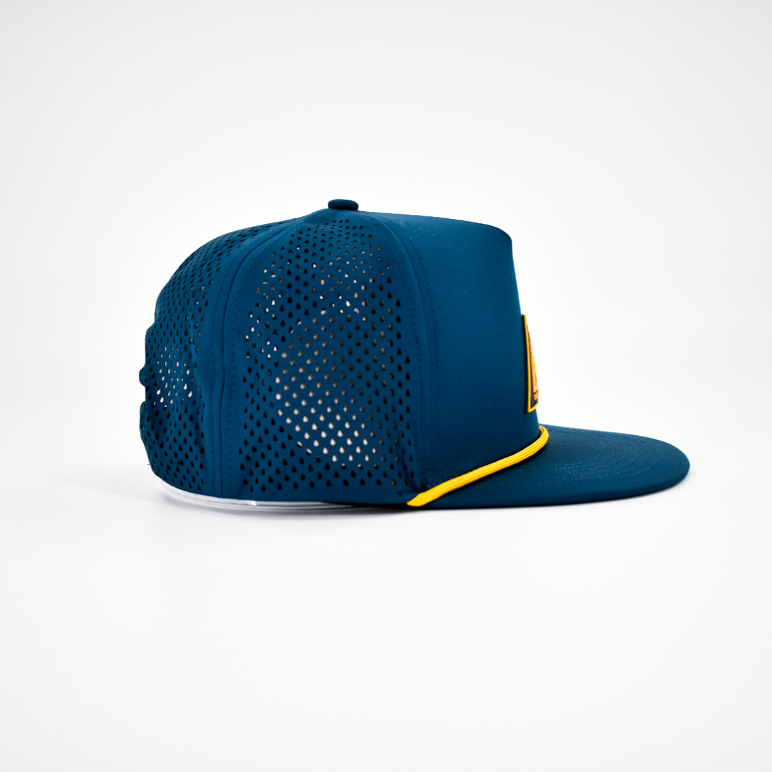 Side view of pewter snapback hat with laser-cut tear drops for breathability.