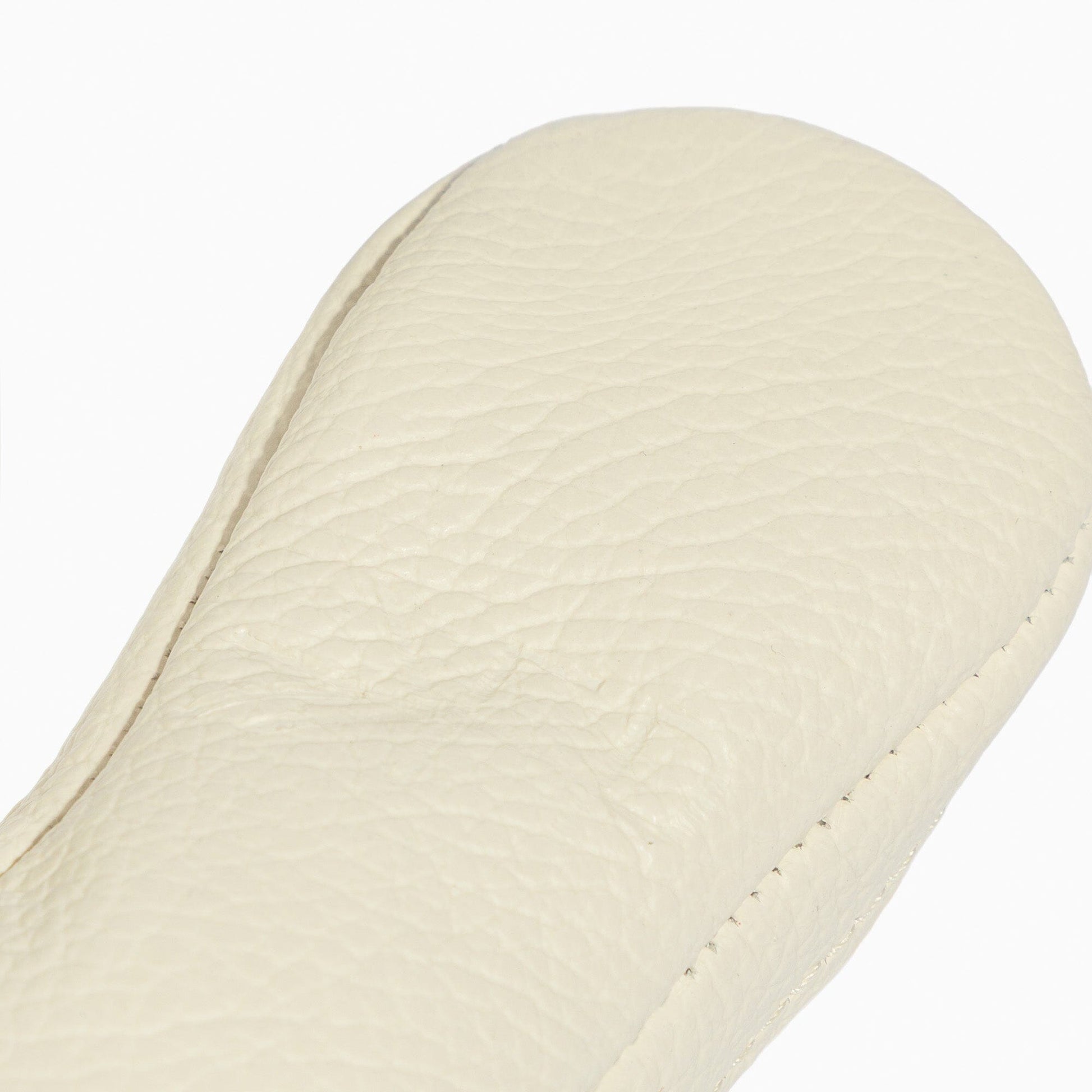 Close-up of the white leather sole of a baby shoe.