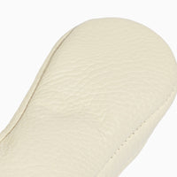 Close-up of the white leather sole of a baby shoe.