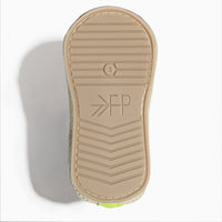 Close-up of the white leather sole of a baby shoe.