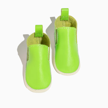 Pair of lime green leather slip-on baby shoes.