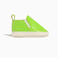 Side view of a lime green leather baby slip-on shoe.