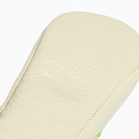 Close up of the white leather sole of the lime green baby shoe.